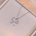 Silver bow heart pendant necklace with radiant baguette zircon on champagne silk background - Silver