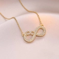 Elegant gold infinity pendant necklace with cubic zirconia on champagne silk background - Infinity Heart Pendant Style (348) / Gold