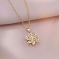 Rotating flower pendant necklace with clear zircons on gold plated chain and lilac background - Gold Rotating Flower Necklace