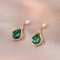 Elegant gold earrings with teardrop emerald stones and pearls on champagne silk fabric - Emerald Teardrop Earrings (E1090)