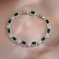 Makroaufnahme von Silberarmband mit smaragdgrünen Edelsteinen und Zirkonia-Clustern - Grüner Rechteckiger Stil (TS0306)