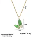 Elegant gold butterfly necklace featuring a green stone wing and sparkling white zircons - Green Butterfly Necklace (X1971)