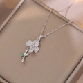 Silver flower pendant necklace with emerald green stone and white cubic zirconia accents - Steel