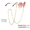 Cadena para gafas con cuentas oro y negro, dijes calados y cierres de mosquetón - 80cm / Dorado