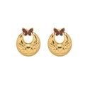 Detailed macro view of golden crescent earrings with embossed floral patterns and brown butterfly - Burgundy