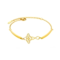 Gold stainless steel bracelet with cutout floral and infinity symbol charms on a white background - Gold