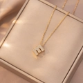 Dettaglio della collana con ciondolo lettera E dorata e micro-pavé di zirconi cubici - Lettera E (X4200)