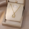 Gros plan du pendentif papillon doré avec zircon sur nacre blanche dans un écrin cadeau - Style Relief Papillon Rond Or (X4364)