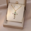 Detailed shot of golden cross pendant with colorful zircon stones in a jewelry box - Gold Geometric Multicolor Stone Cross (X4404)