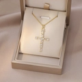 Detailed view of a gold cross pendant necklace featuring sparkling zircon gemstones - Gold White Zircon Cross (X4405)