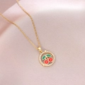 Detailed close-up of a gold cherry pendant necklace with red enamel and crystals - Round Frame Enamel Cherry (X4436) / Gold