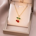 Elegant gold cherry pendant necklace with red crystals on a minimalist thin chain - Gold Green Leaf Cherry