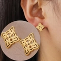 Detailed view of golden Celtic witch knot earrings with symmetrical hollow design - Gold Double Witch Knot