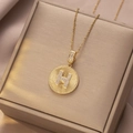 Elegante goldene Titanstahlkette mit Buchstaben-H-Anhänger auf Seidenhintergrund - Gold - Buchstabe H