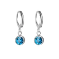 Silver-toned hoop earrings with faceted blue birthstone crystal charms on white background - Steel Tone September-Sapphire Blue