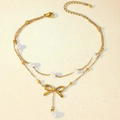 Close-up of golden double-layer anklet with pearl beads and elegant butterfly charm - Double Layer Bowknot Pearl Style (TL0026)