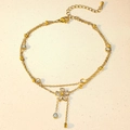 Macro detail of gold-plated double-layer anklet featuring zircon flower and teardrop charms - Double Layer Rhinestone Five-Petal Flower Style (TL0012)