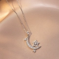 Macro shot of silver moon and star pendant necklace on pink silk fabric background - Nested Star and Moon Style (X4188) / Silver