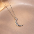Detail of silver crescent moon necklace with sparkling zircons on pink silk fabric - Polished Zirconia Crescent Style (X4191) / Silver