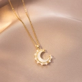Detail of crescent moon pendant with pearls and stars on a champagne fabric background - Pearl and Shell Edged Moon Style (X4192) / Gold