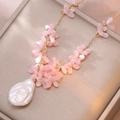 Elegant gold necklace featuring pink flower beads and a large baroque pearl pendant - Necklace (X3677)