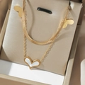Detail einer zweilagigen goldnen Titanstahlkette mit Herzanhänger und Schlangenkette - Zweilagige Schlangenkette Muschel Herz Stil (T0494)