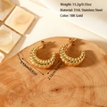 Macro detail of 18K gold plated stainless steel croissant earrings on a rustic wood base - Twisted Croissant Style (ES-110170)