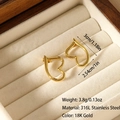 Detail of gold heart-shaped 316L stainless steel earrings on a beige velvet jewelry tray - Minimalist Heart Frame Style (ES-110053)
