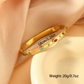 Golden stainless steel eye bangle with colorful zircon stones on a ceramic plate - Colorful Zircon Style (SZ-184) / SZ-184 Multi-color