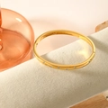 Polished 18K gold-plated stainless steel bangle with sparkling crystals on a jewelry pillow - Dot Rhinestone (SZ-299) / Gold