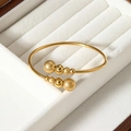 Elegant 22k gold plated open cuff bracelet with polished and frosted beads on white velvet - Eight Beads Style (SZ-056)