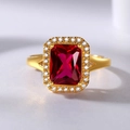 Close-up of luxury gold ring featuring a rectangular red gemstone with halo diamond setting - Red Gemstone Ring