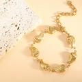 Detail view of a gold-plated shell bracelet with textured charms and lobster clasp - Teardrop Twill (SL-006) / Gold