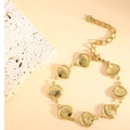 Close-up of golden stainless steel bracelet with shell charms and adjustable lobster clasp - Scallop (SL-007) / Gold