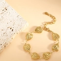 Close-up of golden stainless steel heart charms with striped texture and lobster clasp - Crown (SL-008) / Gold