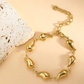 Macro shot of gold stainless steel water drop chain bracelet with lobster clasp detail - Chili (SL-014) / Gold