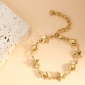 Detail of gold star and diamond charms on a stainless steel bracelet with lobster clasp - 3D Star (SL-017) / Gold