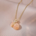 Golden necklace with peach marble money bag pendant and sparkling zircon details - Peach Money Bag (Gold Chain)