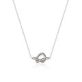 Detailed view of silver knot pendant necklace with elegant cross chain on white background - Necklace / Steel
