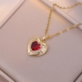 Elegant gold heart pendant necklace with ruby red zirconia and sparkling star accents - Necklace / Red