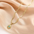 Detail of gold flat snake chain necklace with a turquoise teardrop pendant on silk - Sunburst Turquoise Waterdrop Style