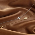 Elegant gold and silver Evil Eye necklaces with sparkling zircon on dark silk fabric - Evil Eye Bracelet (AL-0817) / Gold
