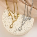 Detail of double-layered titanium steel necklace with Hamsa Hand and Evil Eye charms - Layered Hamsa Hand Evil Eye Style