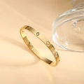 Polished gold stainless steel bangle featuring hollow clover patterns and white cubic zirconia - Gold Style (SZ-011-1)