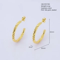 Detail view of 30mm twisted gold hoop earrings made of PVD 18k plated stainless steel - Gold / Large