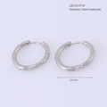 Detailed view of silver stainless steel hoop earrings with hammered texture and 26mm diameter - Extra Large / Steel