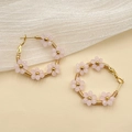 Bohemian large gold hoop earrings with handmade pink beaded flowers for a sweet floral look - Pink