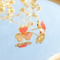 Détail macro de boucles d'oreilles trèfle doré avec émail effet marbre rouge et rose - Style Rose (TL-DYE0016-pink)