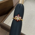 Macro view of vintage fleur-de-lis ring with red enamel and pavé stones on black leather - Fleur-de-lis Zircon Open Ring (JZ4853A)