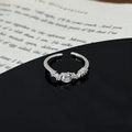 Close-up of sparkling star-leaf ring with cluster zircon stones on black mirror surface - Cluster Main Stone Pave Style (JZ1827A)